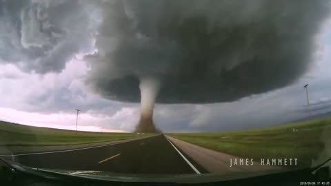 Storm chasing dashcam: Tornado crossing the highway! Laramie, Wyoming