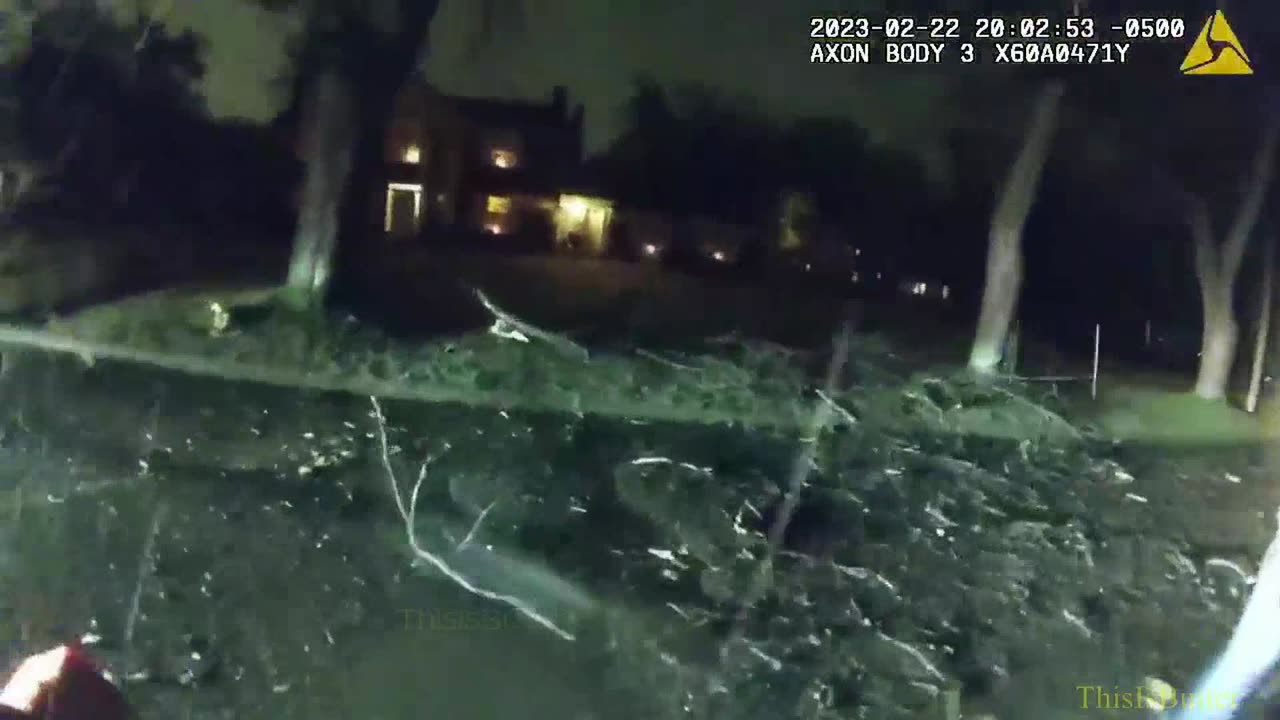 Coach Harbaugh helps police move a tree during ice storms