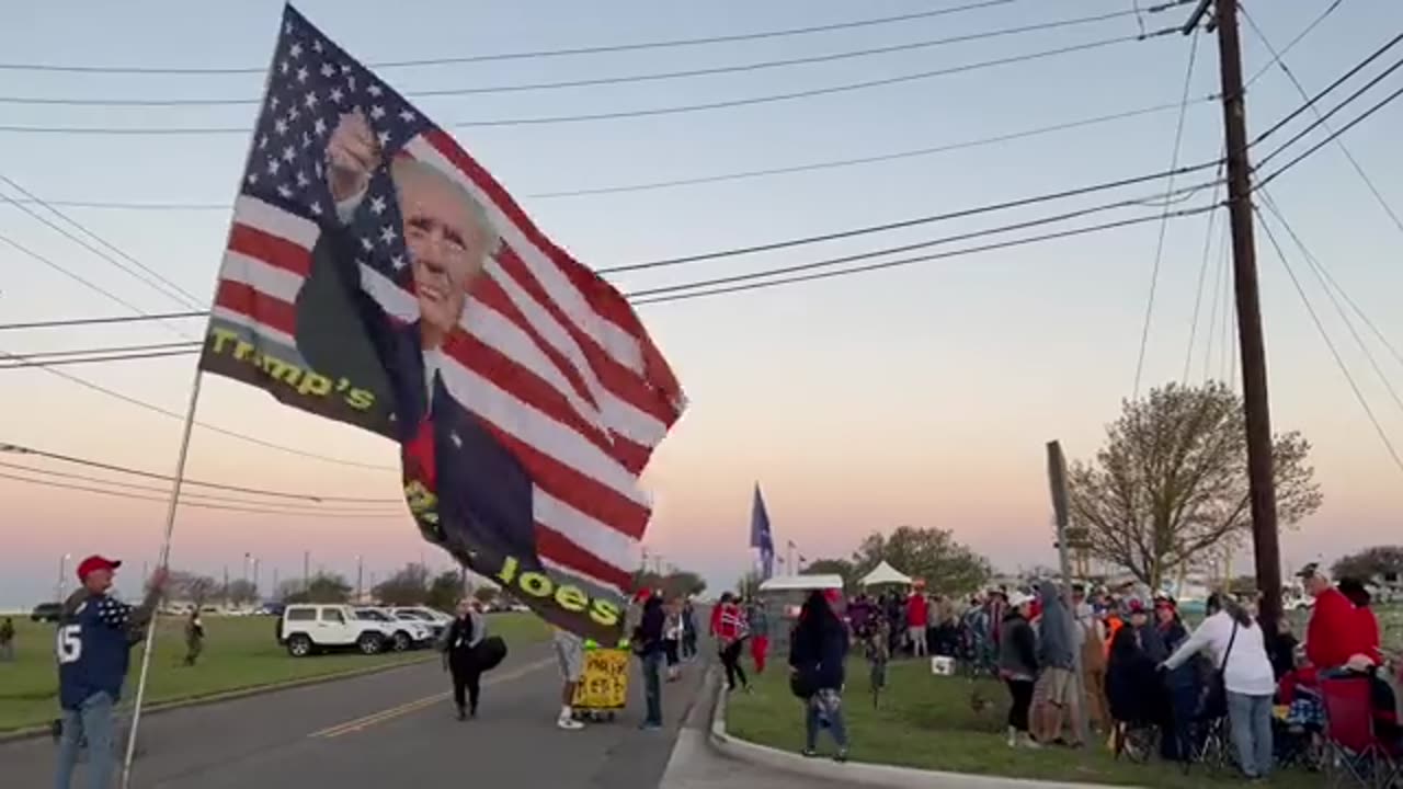 A Trump supporter wearing a 45 shirt waived a huge U.S. flag with an image of