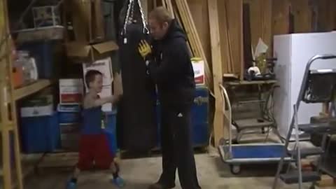 Trevor and Max Walsh working the boxing bag when Max was a wee lad