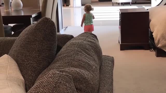 Toddler Laughs Happily on Seeing her Own Reflection in the Mirror