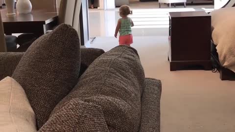 Toddler Laughs Happily on Seeing her Own Reflection in the Mirror