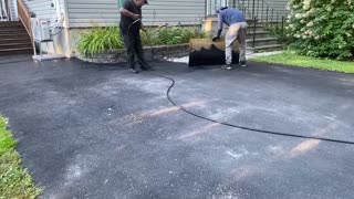 Professional Asphalt Spray Sealing: “The Shiny Red Roof One” Top Coats Pavement Maintenance