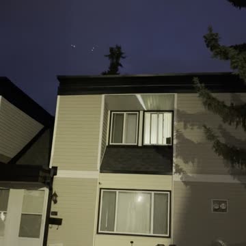 Airplane flies above homes