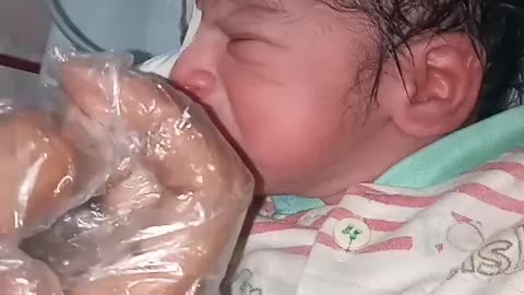 New born baby cleaning with soap and oil