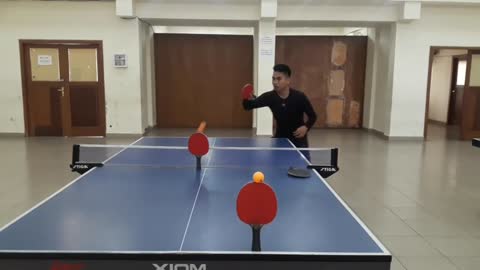 Guy Making A Ping Pong Shot Through 3 Rackets