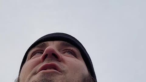 Man wearing mask in car by himself