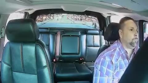 Man drives through a parade route