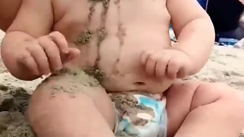 Funny baby reaction on a beach