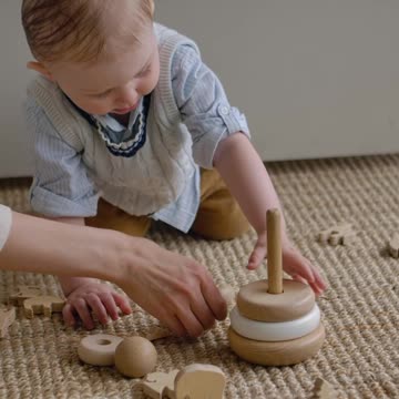 cute little boy playing with mom