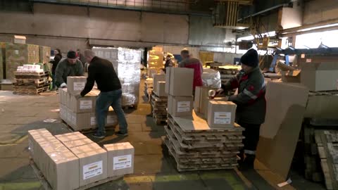 Ukraine factory workers focus on aid amid air raid sirens