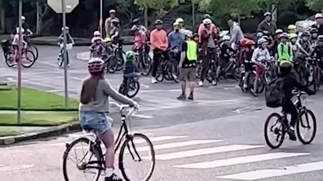 These kids ride a 'bike bus" to school, while residents line the streets and cheer.
