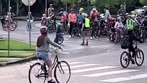 These kids ride a 'bike bus" to school, while residents line the streets and cheer.