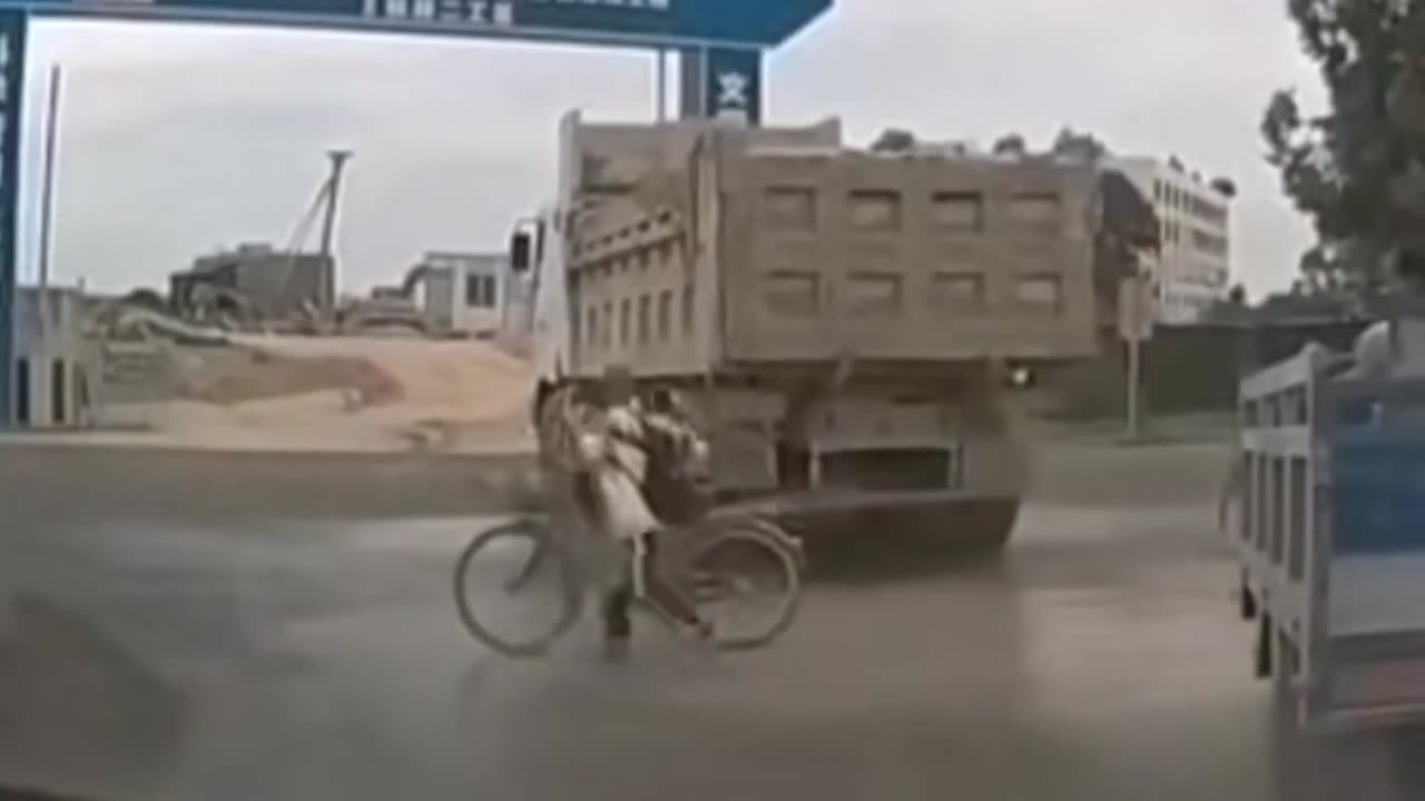 Funny moment boy gets doused in truck mud on his way to school