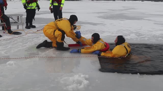 Fort McCoy Firefighters train on surface ice rescue skills at frozen installation lake