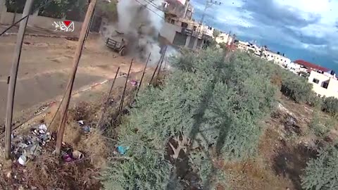 Palestinian resistance forces detonate an explosive device on an Israeli military jeep