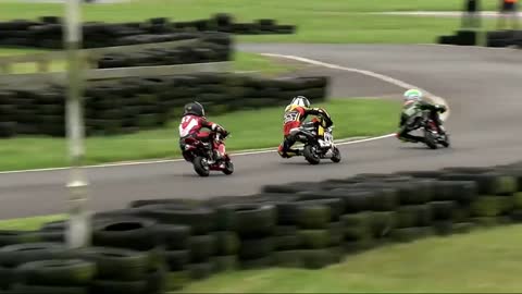 Babies riding motorcycles in an excellent motorcycle race!