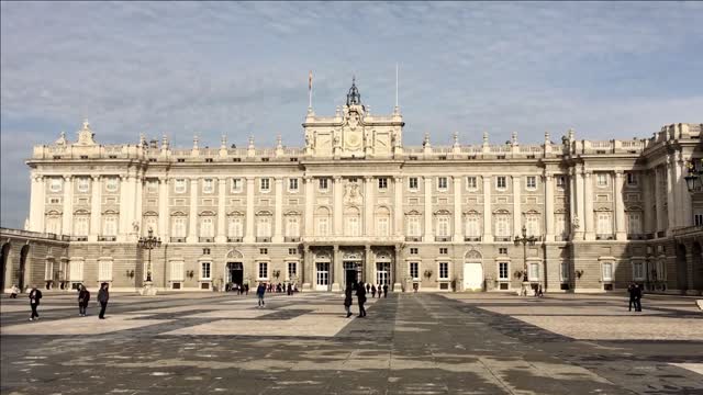 city madrid in spain visitors in front of historical complex of building