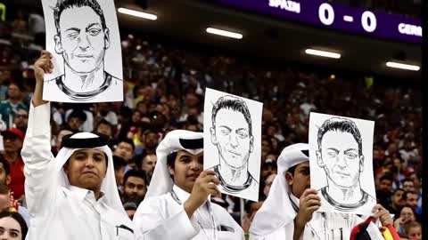Fans in Qatar held up photos of Mesut Ozil and covered their mouths during Germany vs Spain