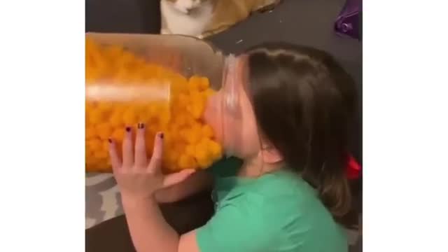 The cat is surprised that the baby is eating