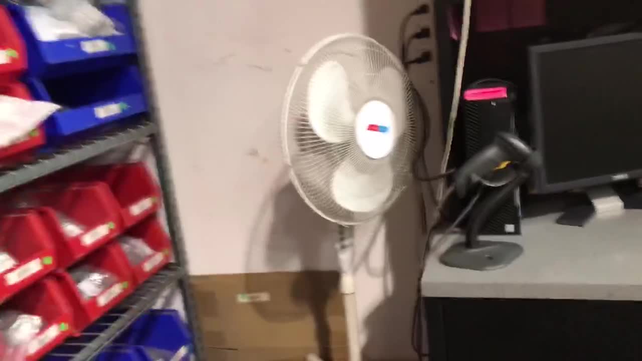 Four fans in a warehouse.