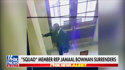 Democrat Rep. Jamaal Bowman removes warning signs before pulling the fire alarm