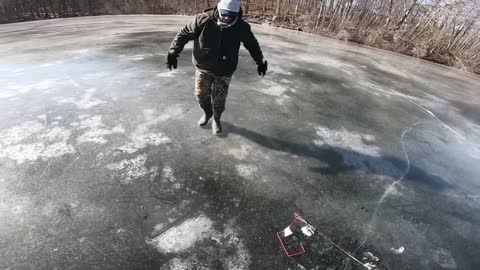 Ice cracks and almost breaks under fisherman