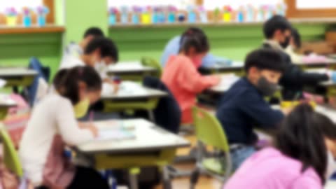 Blurred, students in elementary school classrooms with teachers