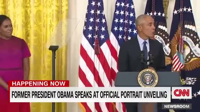 Barack Obama gives a speech after the unveiling of his White House portrait