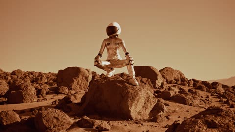 An A stronaut Crouching on top of a rock