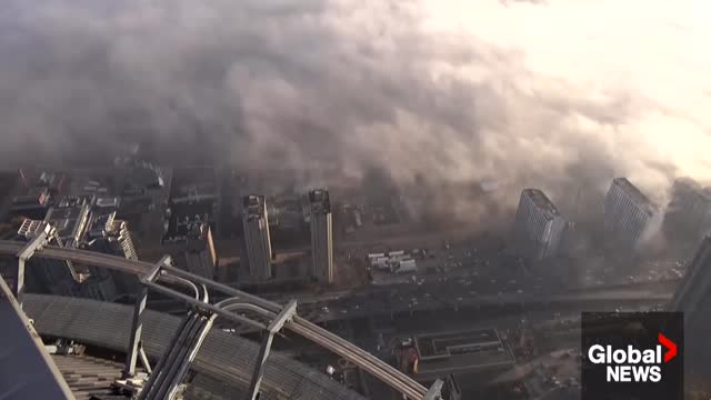 Wall of fog rolls across Toronto from Lake Ontario, creating an eerie scene