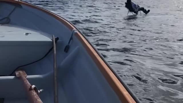 Man Fishes on Ice Block in the Middle of the Lake