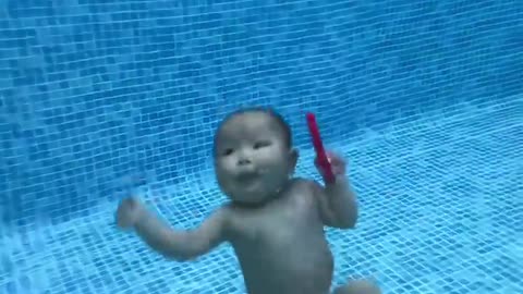 Cute baby swimming in pool