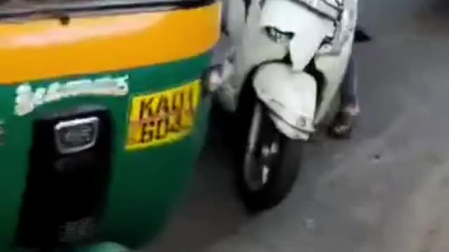 Man being dragged behind a scooter on Bengaluru's Magadi road