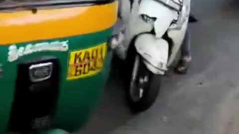 Man being dragged behind a scooter on Bengaluru's Magadi road