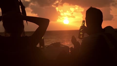 Drink beer on the beach at sunset