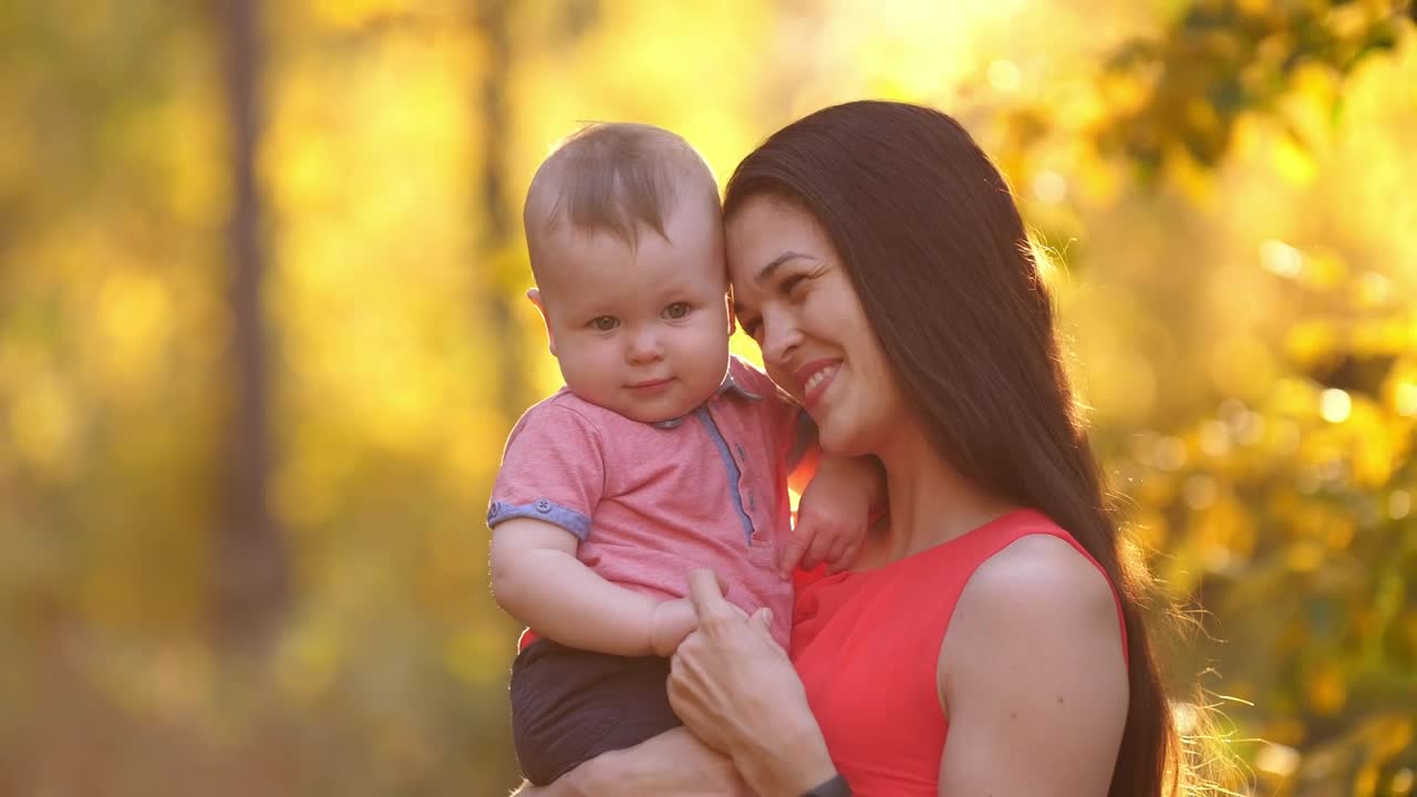 Young happy mother with her baby in nature