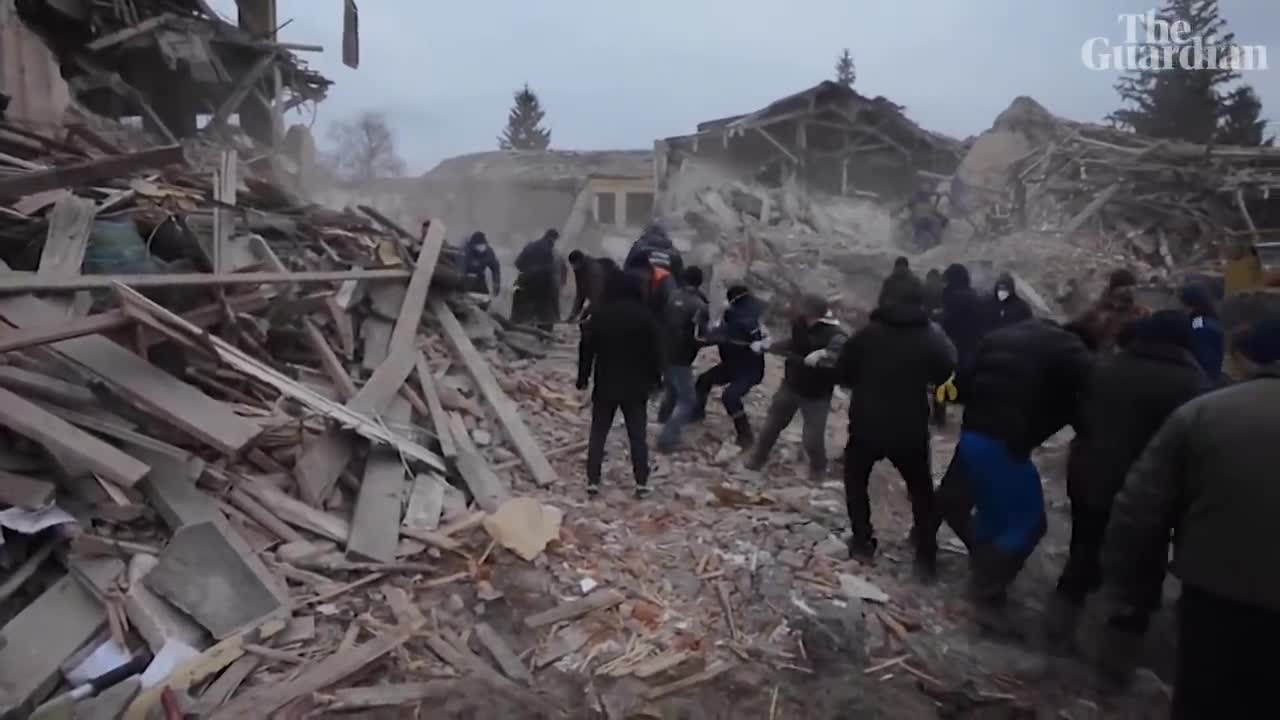 Ukrainian soldiers search through rubble in Okhtyrka after apparent Russian shelling