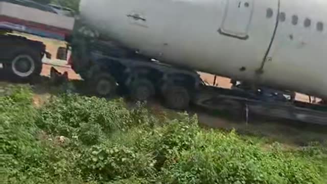 A passenger plane being carried by trailer in Nigeria