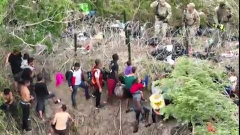 National Guard blocks migrants from crossing river