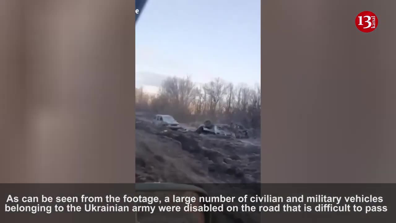 krainian soldiers display destroyed vehicles along the road in Bakhmut