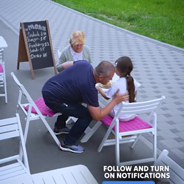 Father and daughter give up meal for elderly woman in need.