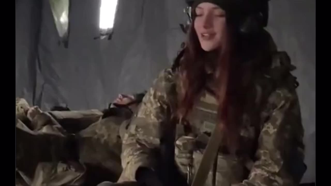 UA POV: Ukrainian female soldier singing a tune to the accompaniment of explosions.