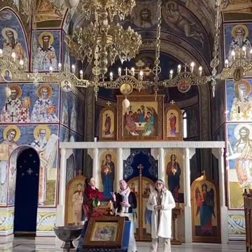 Trio of women sing inside an Orthodox Church