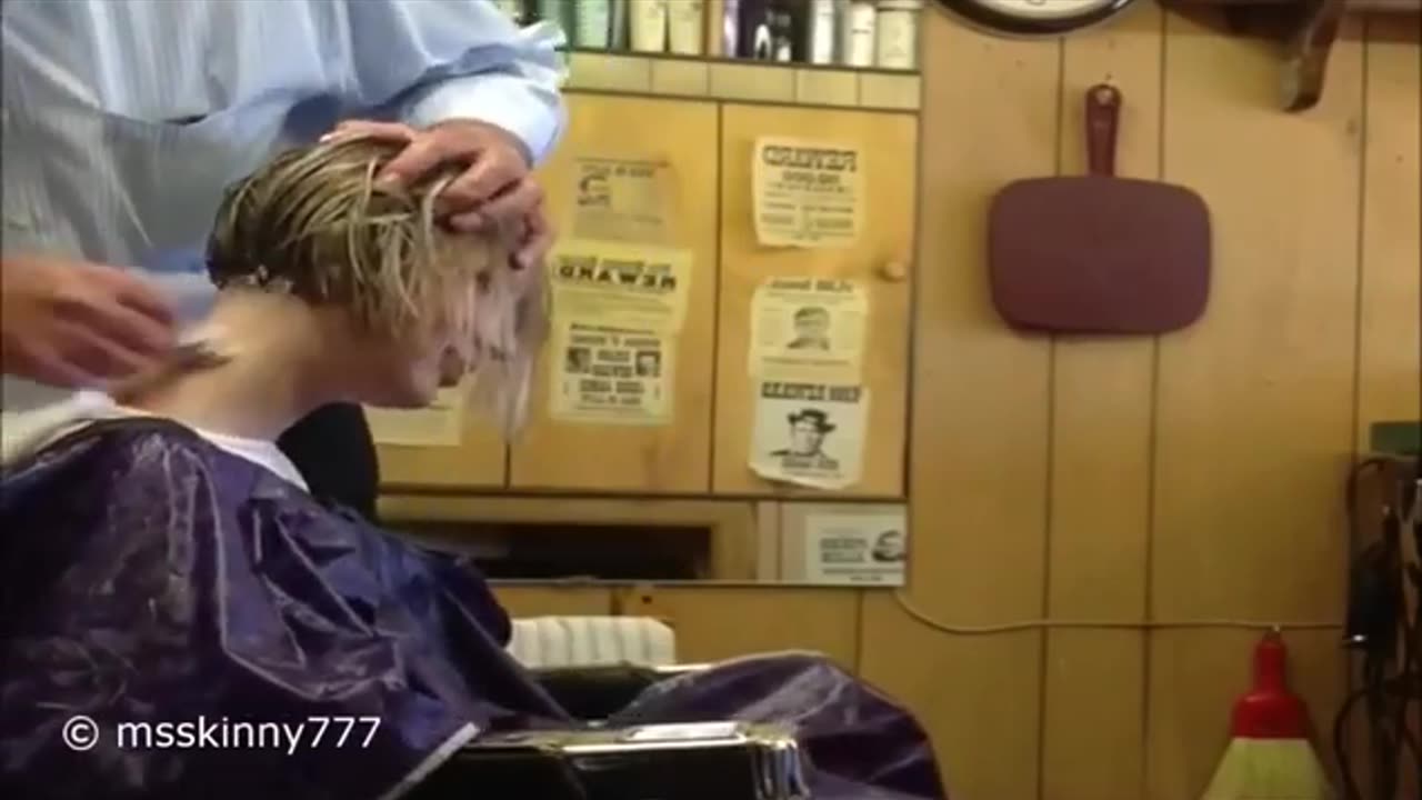 girl gets her nape shaved at the barbershop