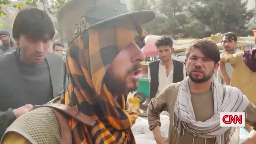 Taliban fighters block Afghans with papers from reaching airport.