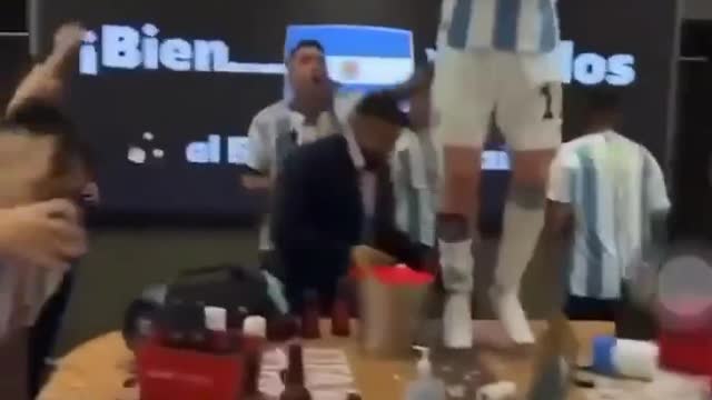 Lionel Messi dances with the World Cup trophy inside Argentina dressing room