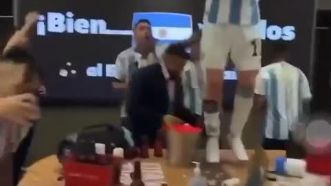 Lionel Messi dances with the World Cup trophy inside Argentina dressing room