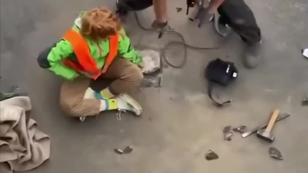 Loser glued his hand to the road in protest of oil.