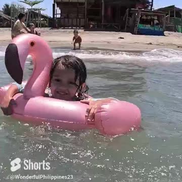 Beach Day Cheeky Riding the Waves on Her Pink Flamingo Floaty